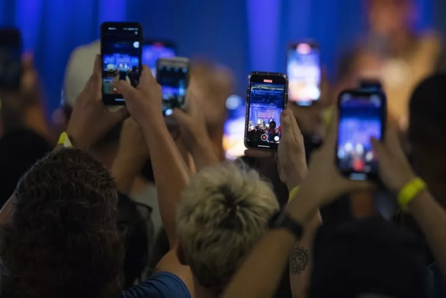 People record on their phones as Kanye West makes his first presidential campaign appearance (The Post And Courier via AP)