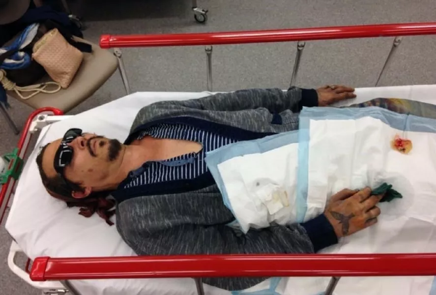 A photo issued by Schillings of Johnny Depp being taken to hospital with a severed finger, following an incident in Australia in March 2015 (Schillings/PA)