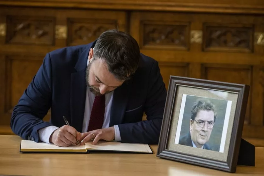 SDLP leader Colum Eastwood signs a book of condolence at Guildhall in Derry City (Liam McBurney/PA)