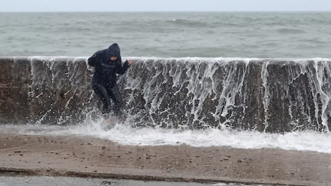 A person is hit by a wave crashing on the Front Strand in Youghal, Co Cork on Wednesday evening. Photo: Niall Carson/PA