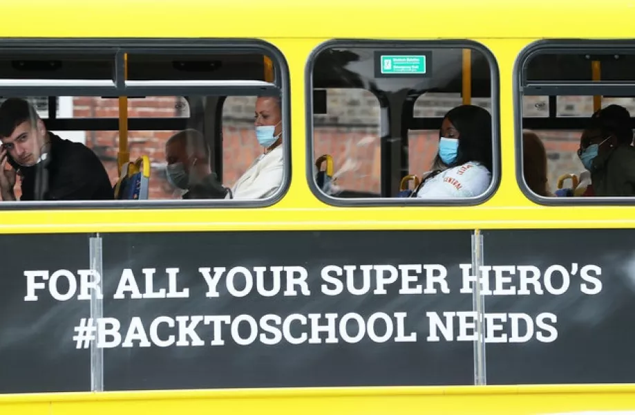 An advertisement for a school book supplier on the side of a bus in Dublin (Brian Lawless/PA)