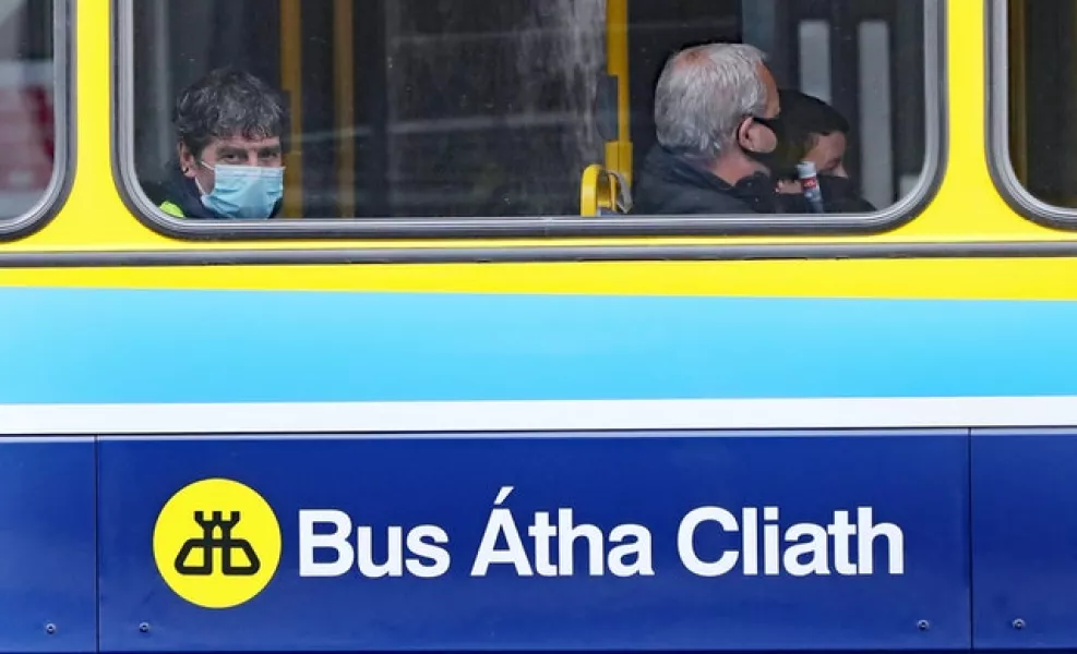 People riding a bus in Dublin wear face coverings (Niall Carson/PA)
