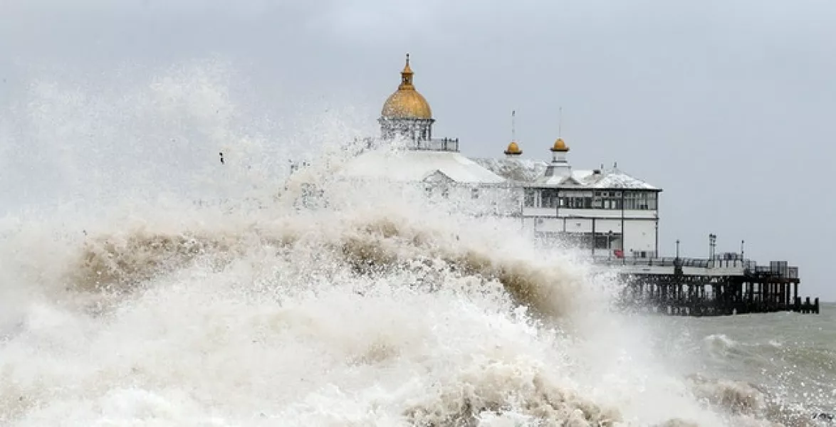 Waves crash near the pier in Eastbourne in the UK in August. (Gareth Fuller/PA)