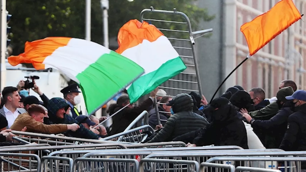 Anti-lockdown protesters (left) clash with counter demonstrators (right) during an anti-lockdown protest outside Leinster House, Dublin. Photo: Brian Lawless/PA Images.
