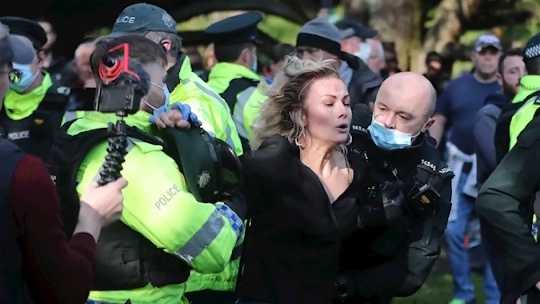 Police officers detain an anti-lockdown protester on the Stormont estate in Belfast. Photo: Niall Carson/PA Images.