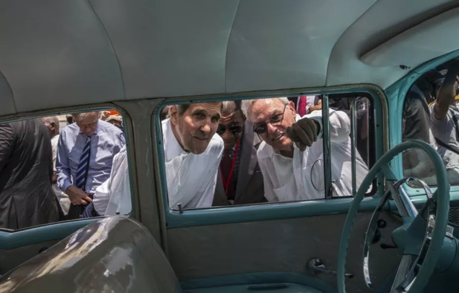 FILE – In this Aug. 14, 2015 file photo, Havana city historian Eusebio Leal Spengler, right, points out something to then US secretary of state John Kerry as they peer into the interior of a classic American car parked in Old Havana, Cuba (Ramon Espinosa/AP)