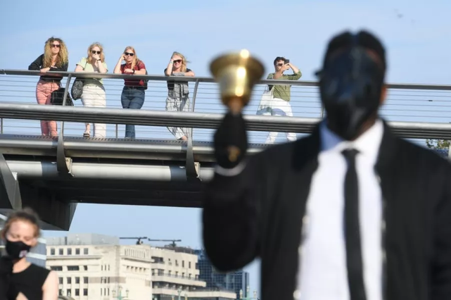 People on the Millennium Bridge watch the funeral procession (Kirsty O’Connor/PA)