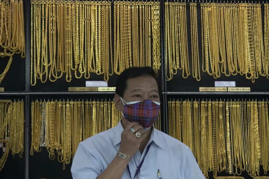 A shopkeeper at a gold shop in Bangkok, Thailand (Sakchai Lalit/AP)