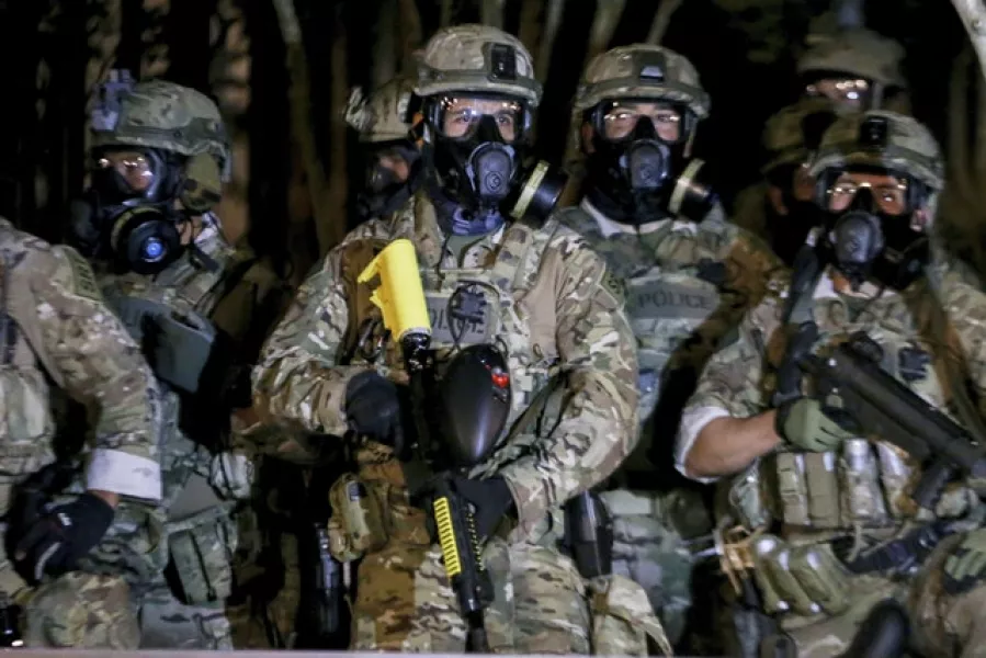 Federal officers deployed tear gas and fired less-lethal rounds into a crowd of protesters late on Thursday (Beth Nakamura/The Oregonian/AP)