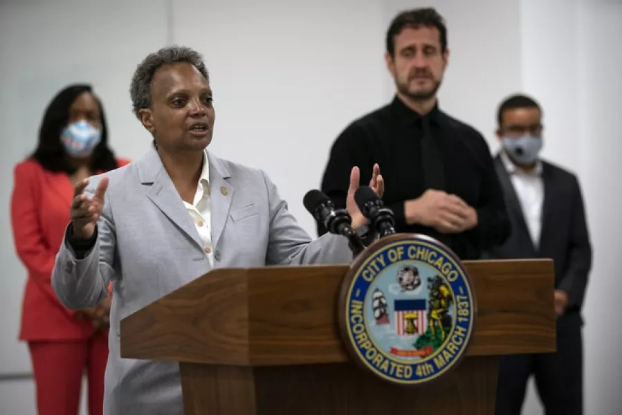 Chicago Mayor Lori Lightfoot, joined by Chicago Public Schools chief Dr Janice K Jackson, left rear, announce a preliminary reopening framework for public schools (E Jason Wambsgans/Chicago Tribune via AP)