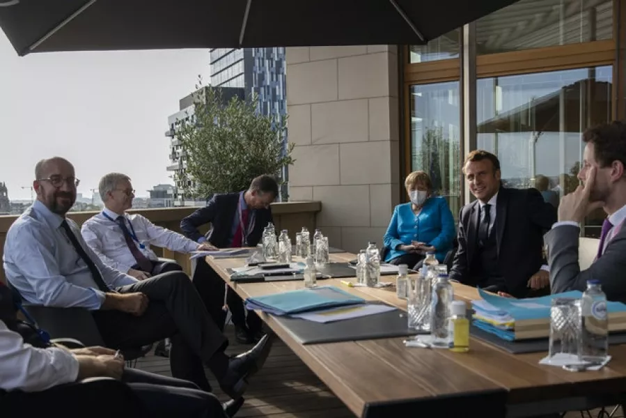 European Council president Charles Michel, left, speaks with Angela Merkel and Emmanuel Macron. Photograph: Francisco Seco/AP