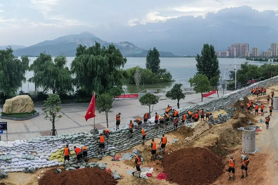 Chinese soldiers build a temporary embankment to contain Poyang Lake (Chinatopix via AP)