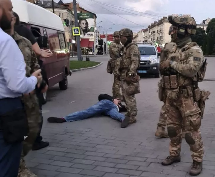 The assailant lies on the ground after police officers captured him (Ukrainian Police Press Office via AP)