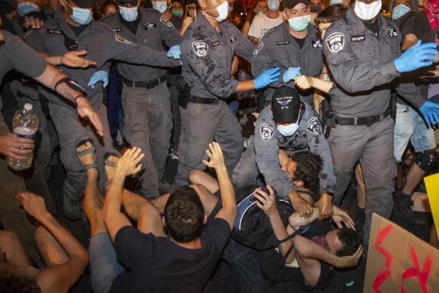 Police confront demonstrators (Ariel Schalit/AP)
