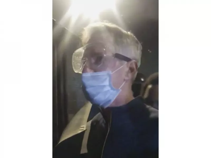 In this image made from video released by Karina Brown, Portland Mayor Ted Wheeler wears googles in thick tear gas as he stands near the federal courthouse in Portland (Karina Brown via AP)