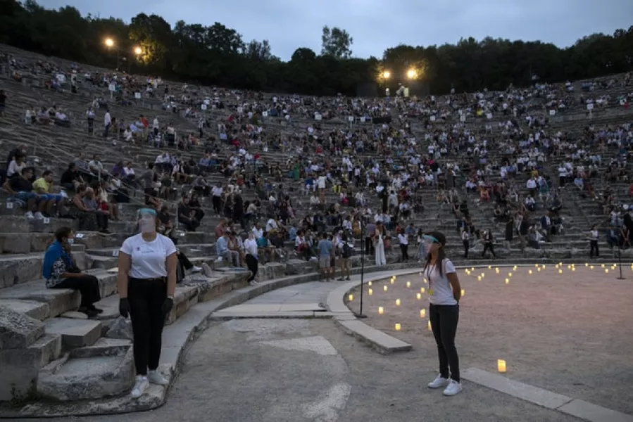 Concert-goers were kept apart and helped to their seats in Epidaurus by stewards wearing surgical gloves and plastic visors (Petros Giannakouris/AP)