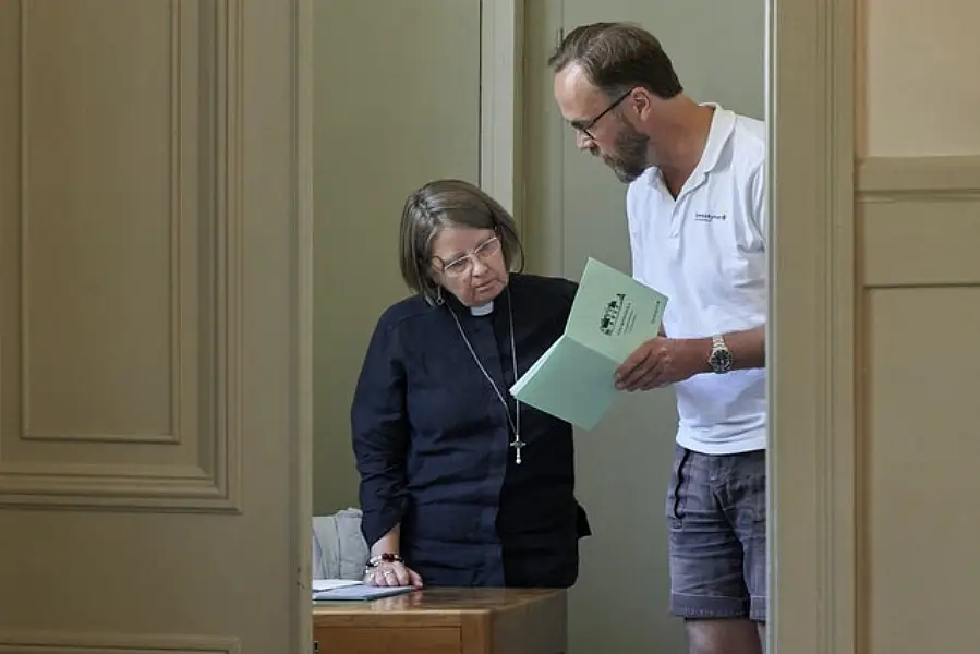 Rev Elisabeth Oberg Hansen reviews the service planned by her student Rikard Kjellman ahead of a sermon in Stockholm, Sweden (David Keyton/AP)