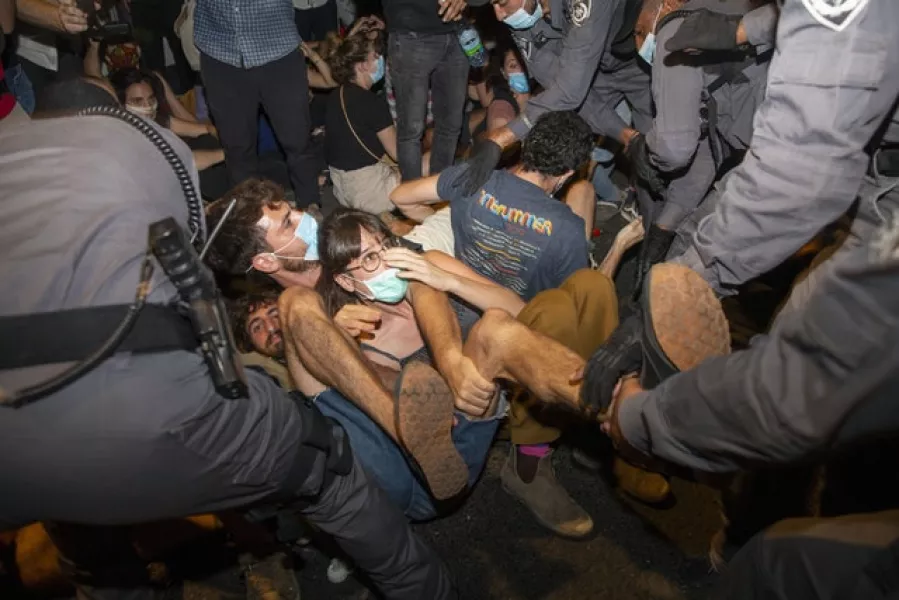 Israeli police officers scuffle with demonstrators outside Benjamin Netanyahu’s official residence in Jerusalem (Ariel Schalit/AP)