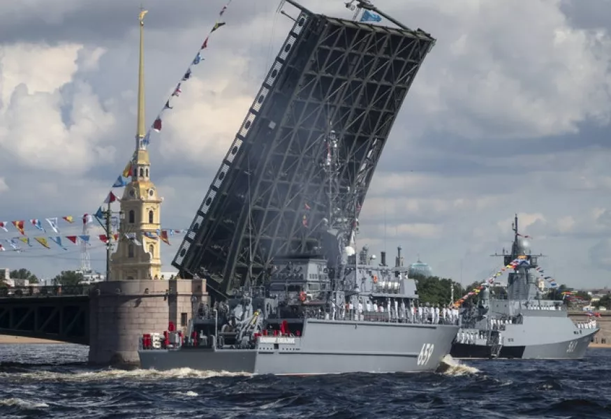 Warships pass the Dvortsovy (Palace) drawbridge rising above the Neva River during the Navy Day parade in St.Petersburg (Dmitri Lovetsky/Pool/AP)