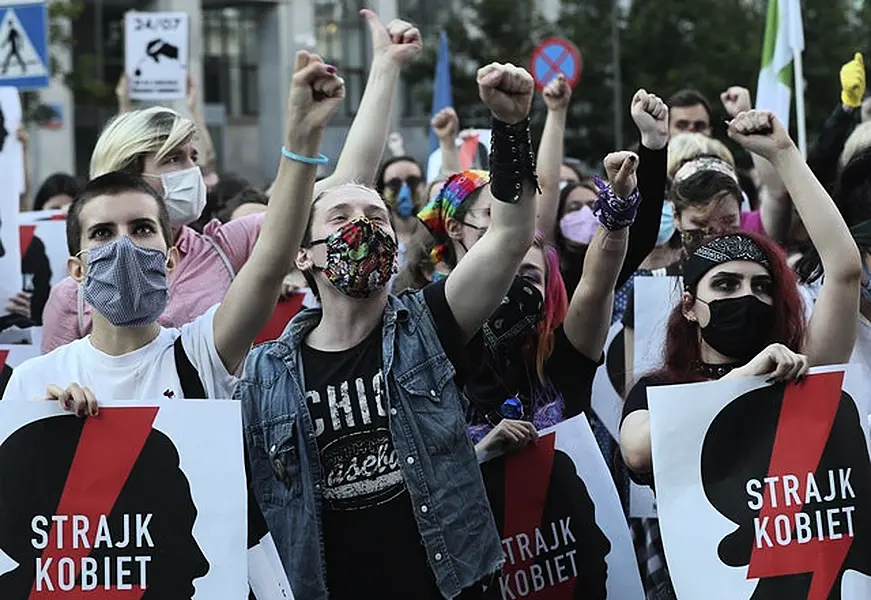 Protesters with a banner reading “Women’s Strike” taking part in a rally against Polish government plans to withdraw from the Istanbul Convention (Czarek Sokolowski/AP)