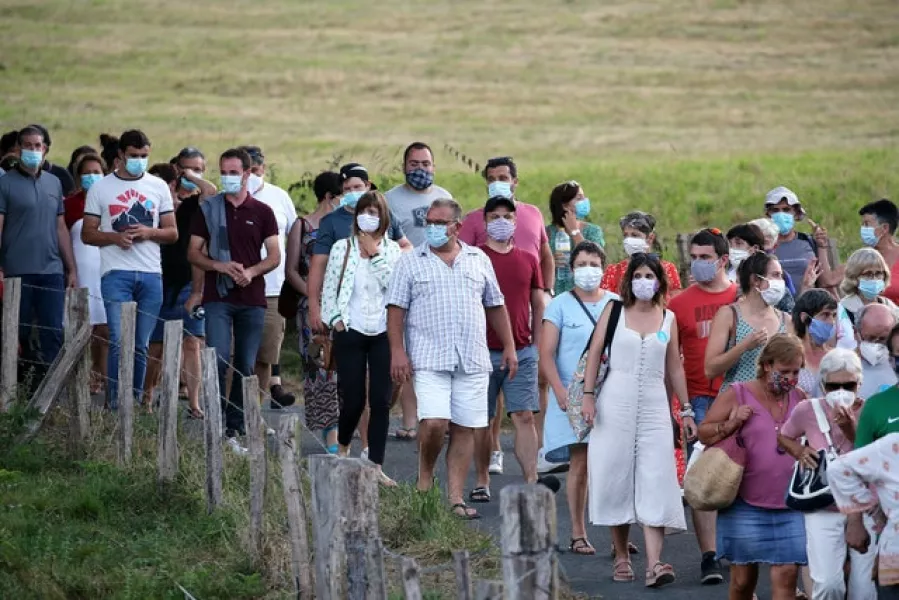 People wear face masks as they leave a music festival in Saint Etienne de Baigorry, southwestern France (Bob Edme/AP)