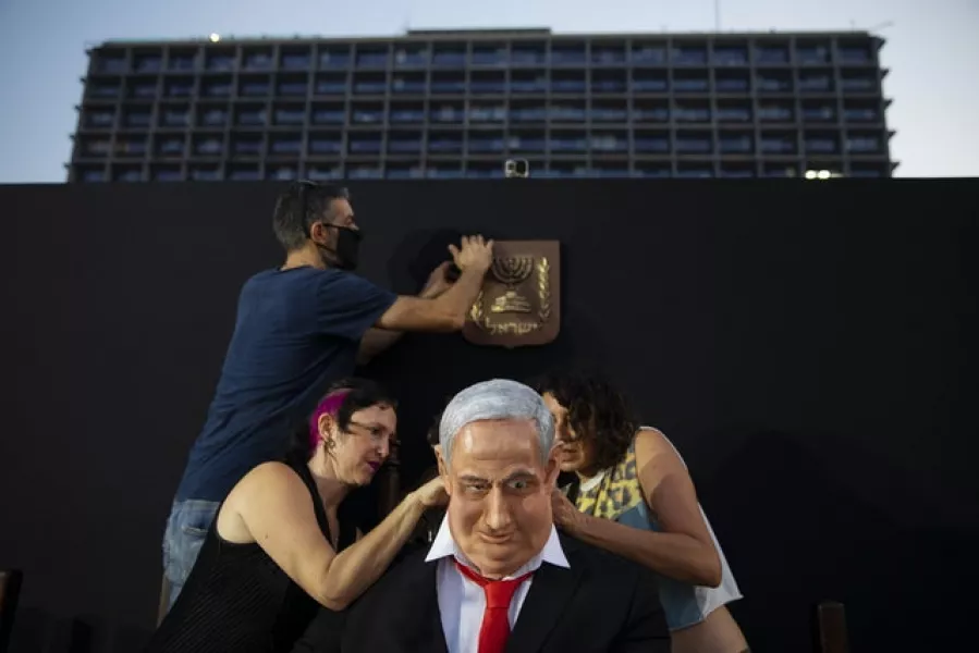 Team members of Israeli artist Itay Zalait work on the statue (AP)