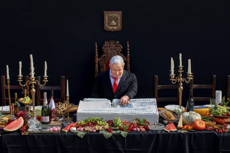 The installation depicts Mr Netanyahu as dining alone in a mock re-enactment of The Last Supper (AP)