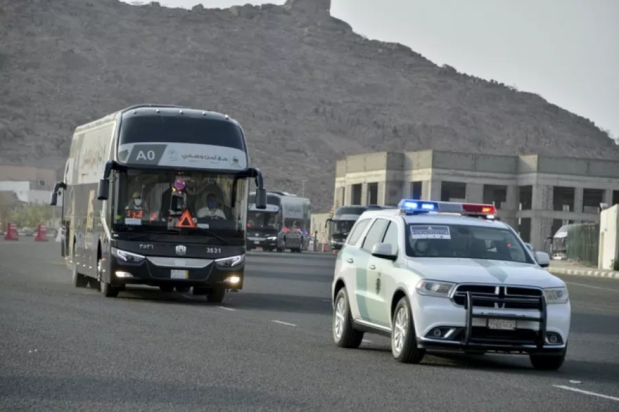 A police vehicle escorts a pilgrim convoy (AP)
