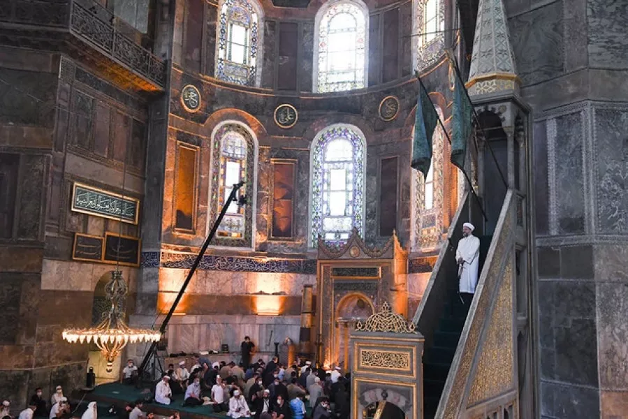Muslims gather inside the Hagia Sophia, recently converted back to a mosque, in Istanbul (Pool via AP)