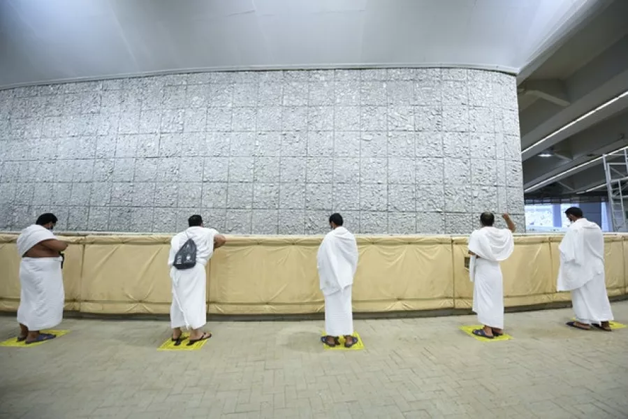 Muslim pilgrims cast stones at a pillar in the symbolic stoning of the devil (Saudi Ministry of Media via AP)
