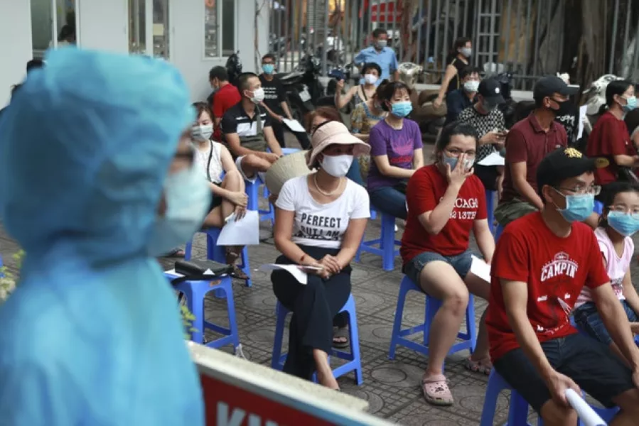 People wait in line for a Covid-19 test in Hanoi, Vietnam (Hau Dinh/AP)