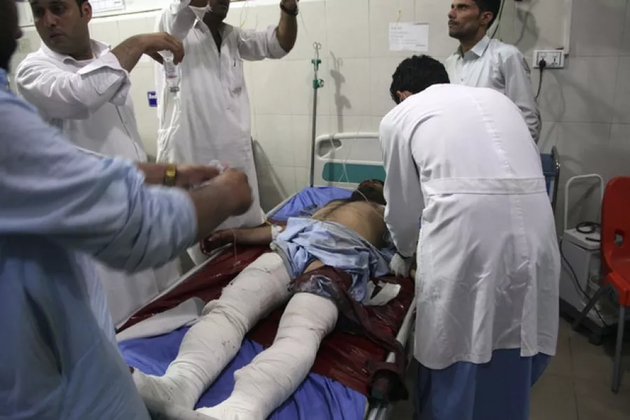 A wounded man receives treatment at a hospital after the suicide car bomb and gun attack in the city of Jalalabad (AP)