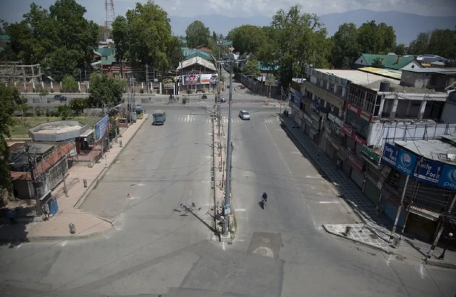 A road stands deserted during curfew in Srinagar (Mukhtar Khan/AP)