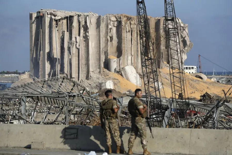 Lebanese soldiers stand guard at the blast scene (Hussein Malla/AP)