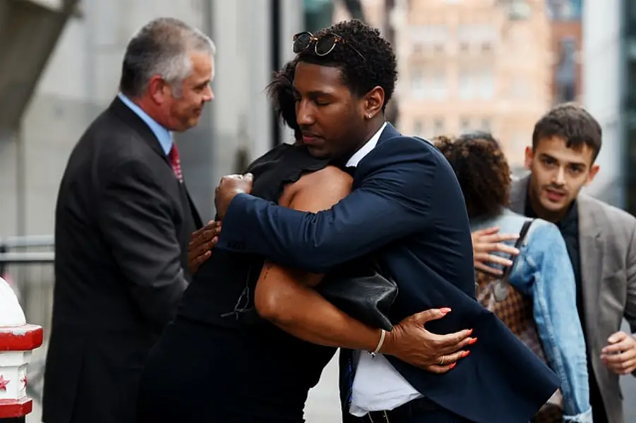 The parents of Tashan Daniel embrace outside the Old Bailey (Kirsty O’Connor/PA)