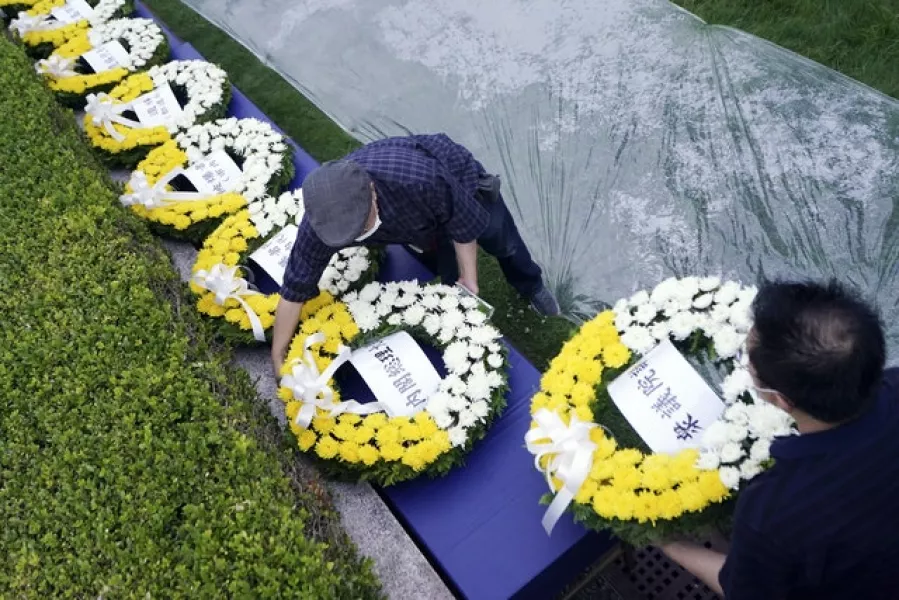 Workers prepared wreaths for the atomic bombing victims (AP Photo/Eugene Hoshiko)