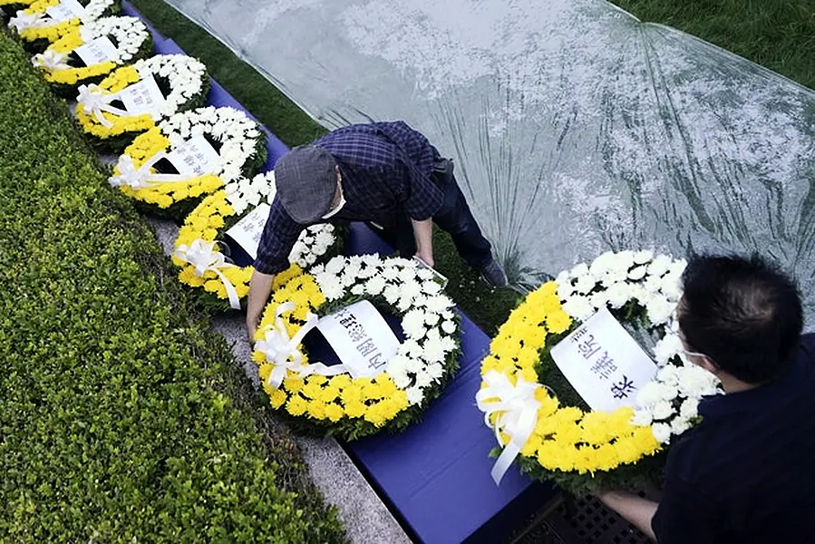 Workers prepared wreaths for the atomic bombing victims (AP Photo/Eugene Hoshiko)