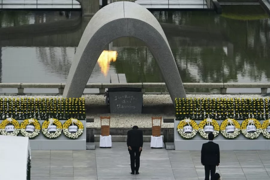 Japanese Prime Minister Shinzo Abe bowed in front of Hiroshima Memorial Cenotaph (AP Photo/Eugene Hoshiko)