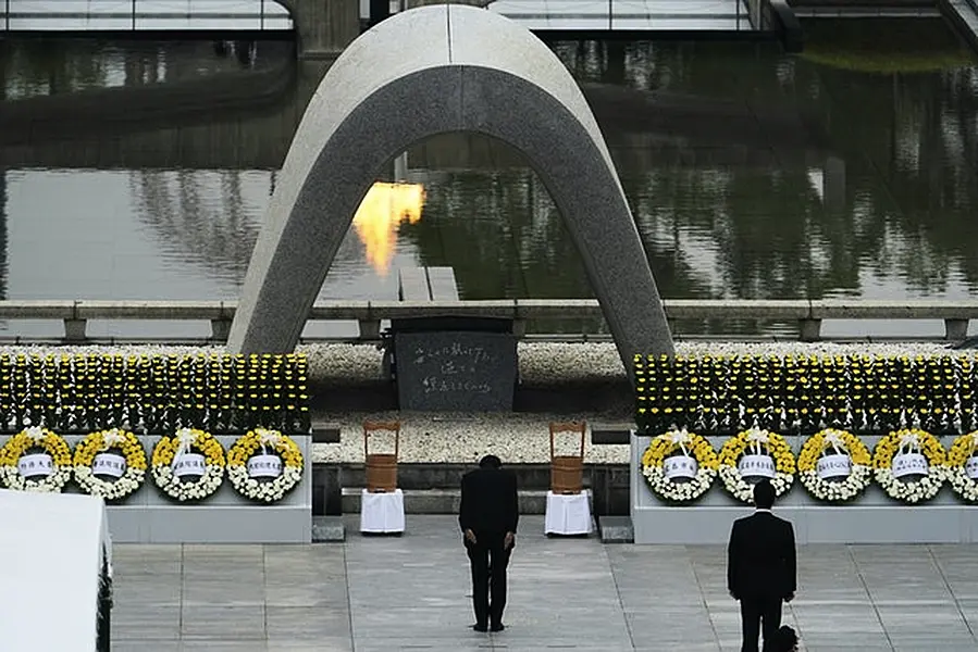 Japanese Prime Minister Shinzo Abe bowed in front of Hiroshima Memorial Cenotaph (AP Photo/Eugene Hoshiko)