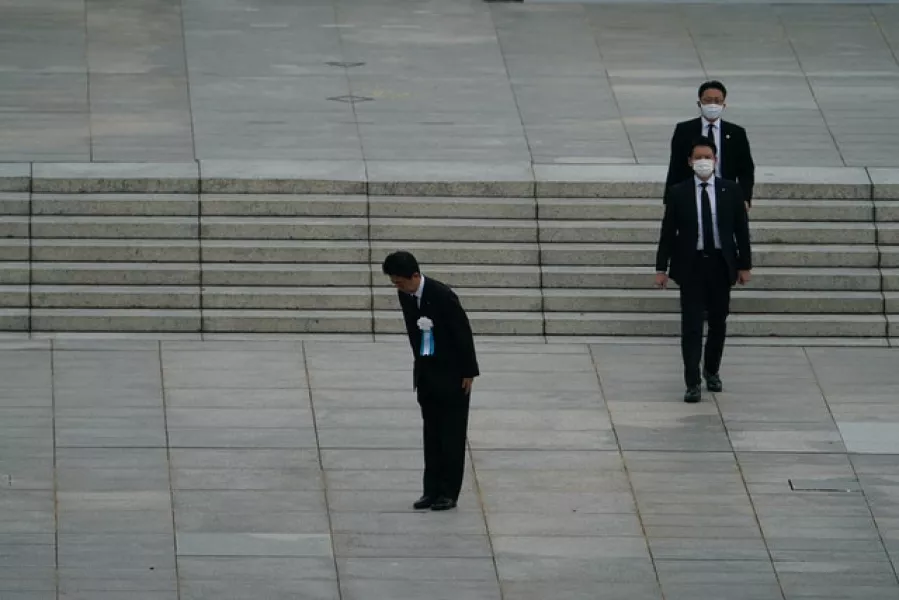 Mr Abe bowed to the families of the victims (AP Photo/Eugene Hoshiko)