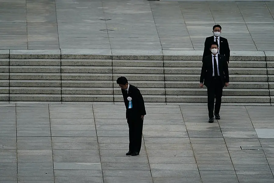 Mr Abe bowed to the families of the victims (AP Photo/Eugene Hoshiko)