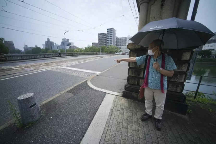 Hibakusha (survivor) Lee Jong-keun shows his position at Kojin Bridge at the moment an atomic bomb exploded in Hiroshima, western Japan (Eugene Hoshiko/AP)