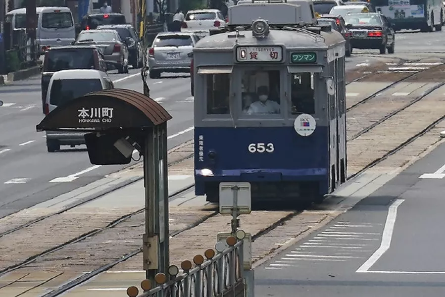 The No 653 tram, which survived the atomic bomb, runs along the street near the Atomic Bomb Dome (Eugene Hosiko/AP)