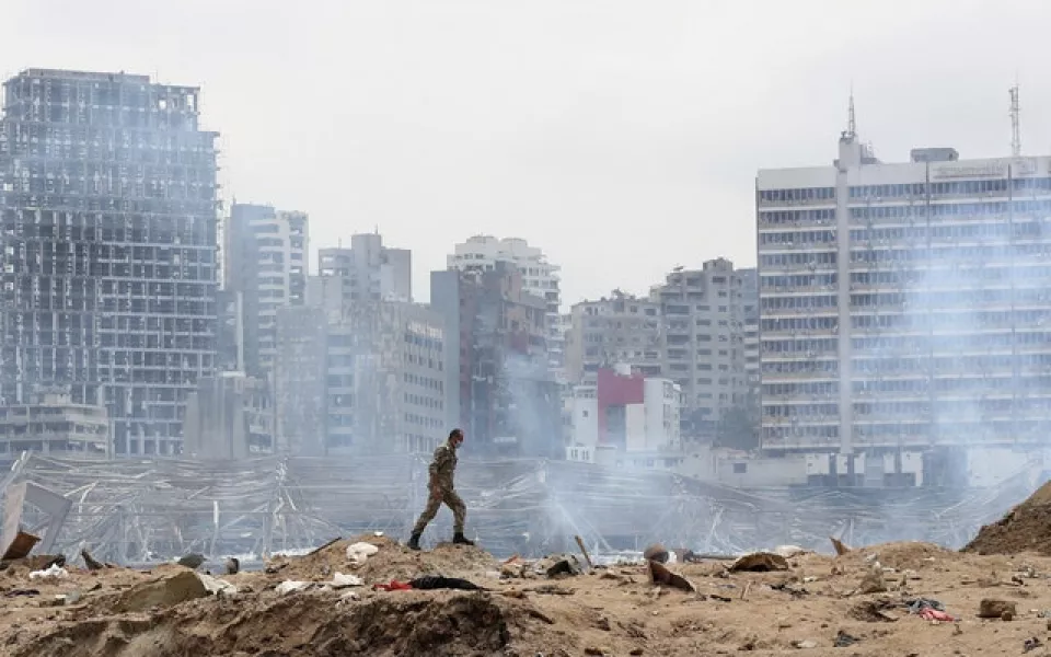 A soldier walks at the devastated site of the explosion (Thibault Camus/AP)