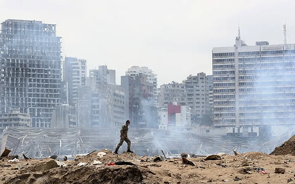 A soldier walks at the devastated site of the explosion (Thibault Camus/AP)