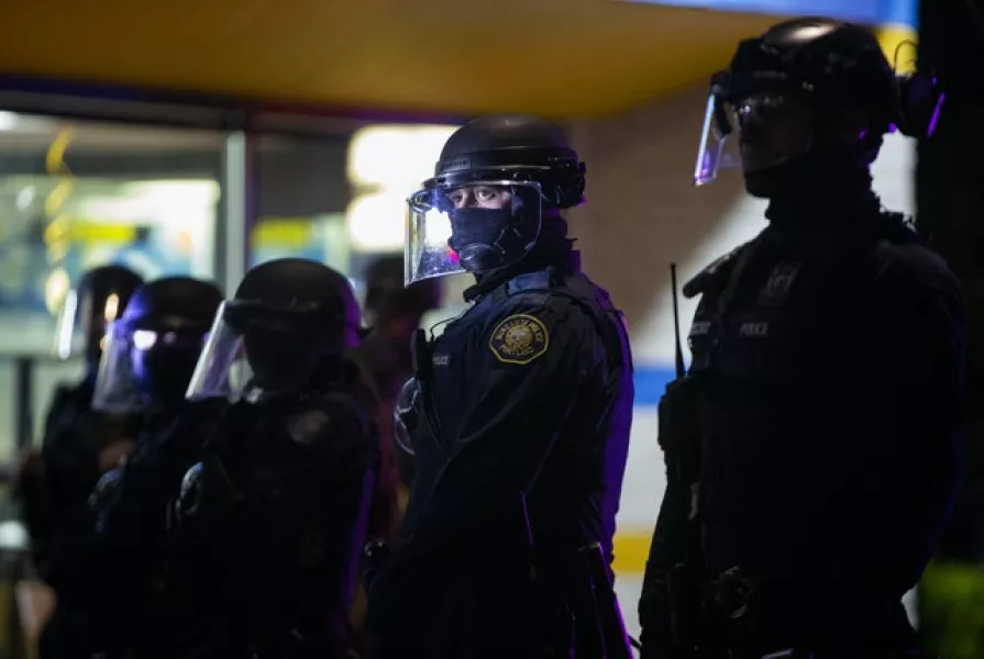 Police stand by during a protest in Portland (Dave Killen /The Oregonian/AP)