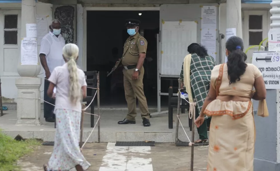 Women arrive to cast votes (Eranga Jayawardena/AP)