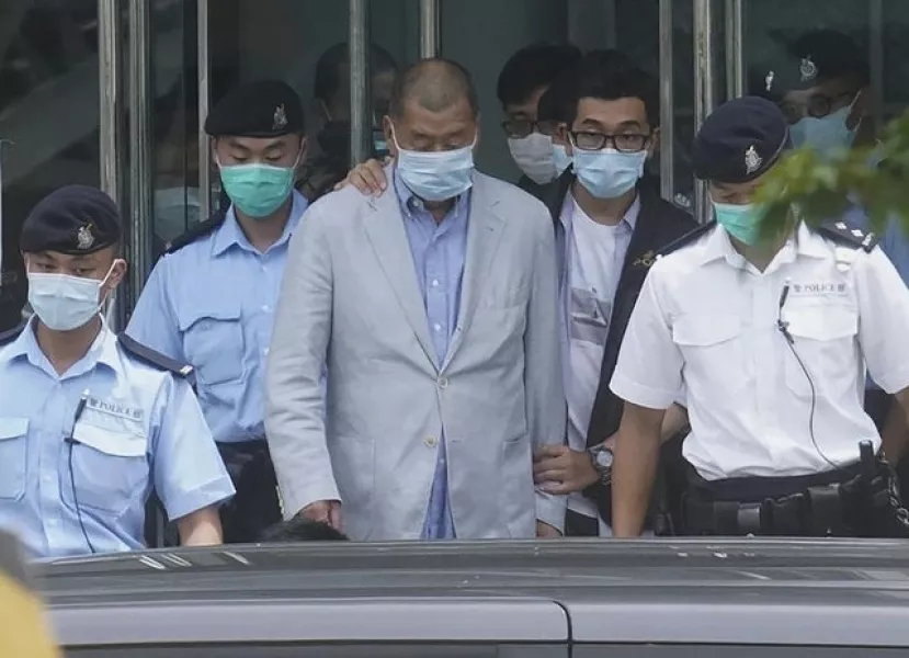 Hong Kong media tycoon Jimmy Lai, centre, is arrested (AP)