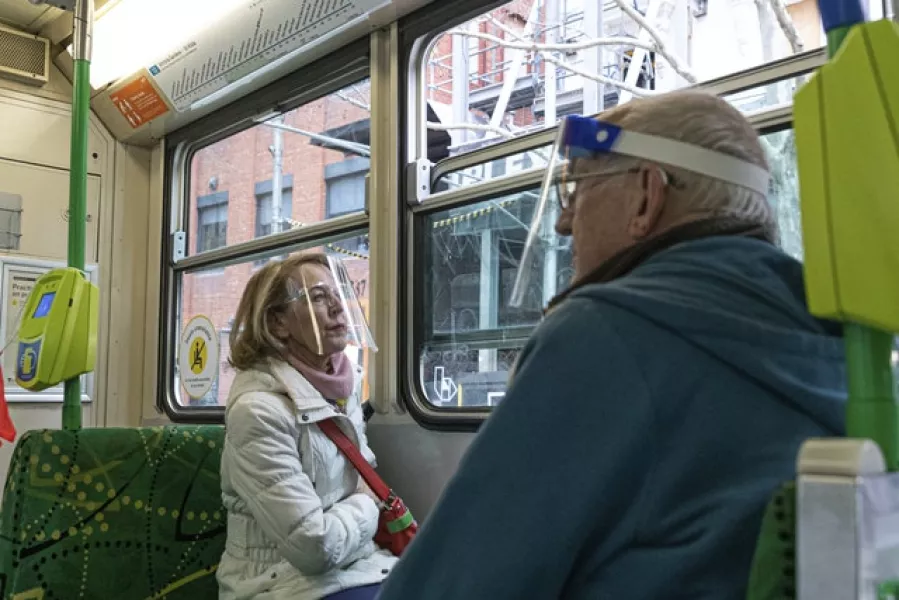 Commuters wearing face shields travelling by tram in Melbourne (AP/Asanka Brendon Ratnayake)