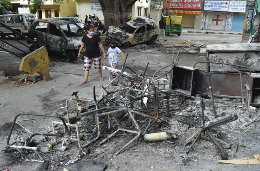 Wreckage on the street after violent protests in Bengaluru (AP)